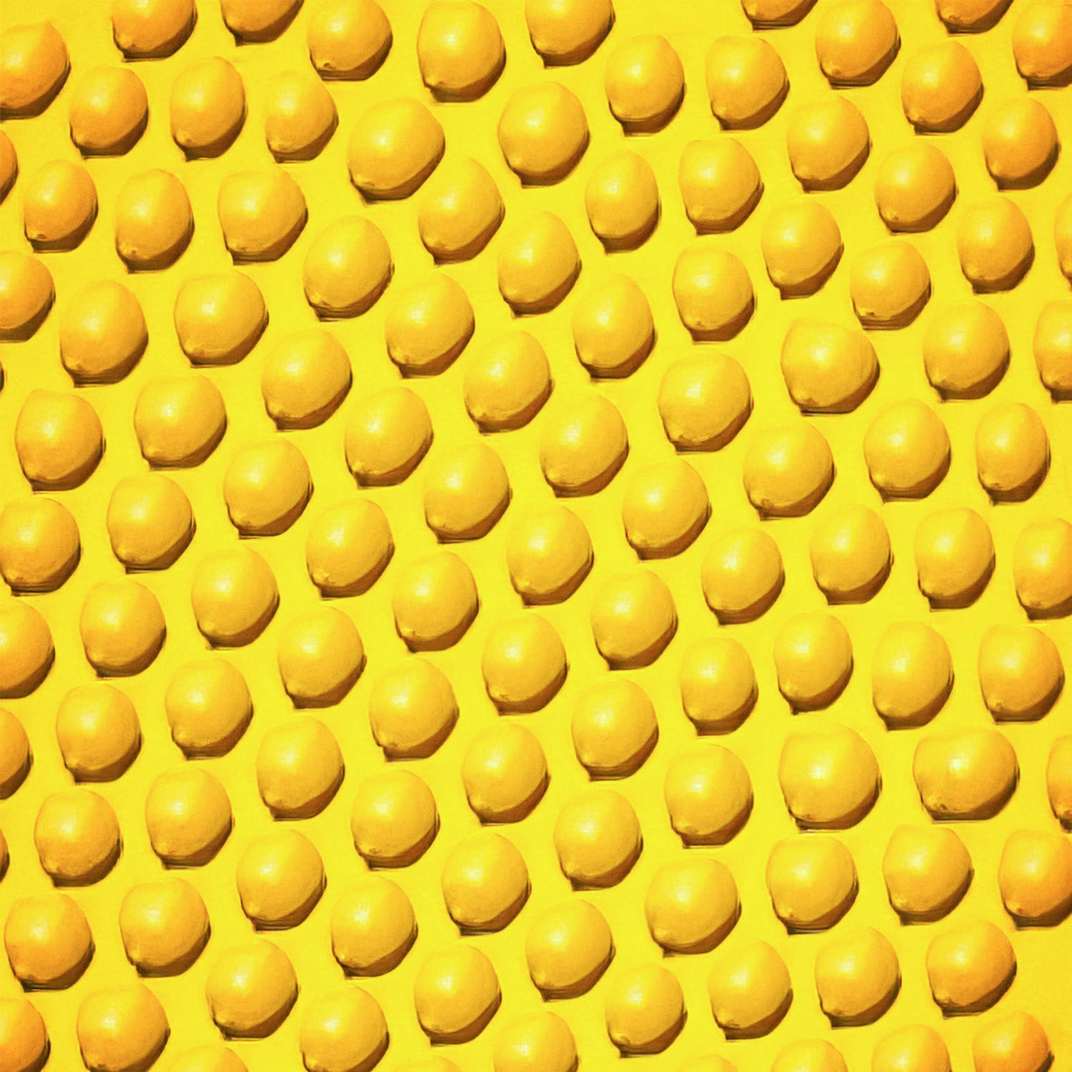 An illustrated pattern of yellow lemons on a solid yellow background.